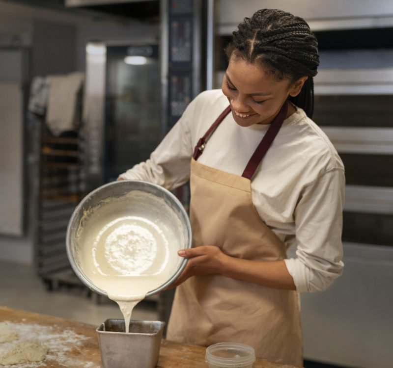 woman-pouring-dough-medium-shot